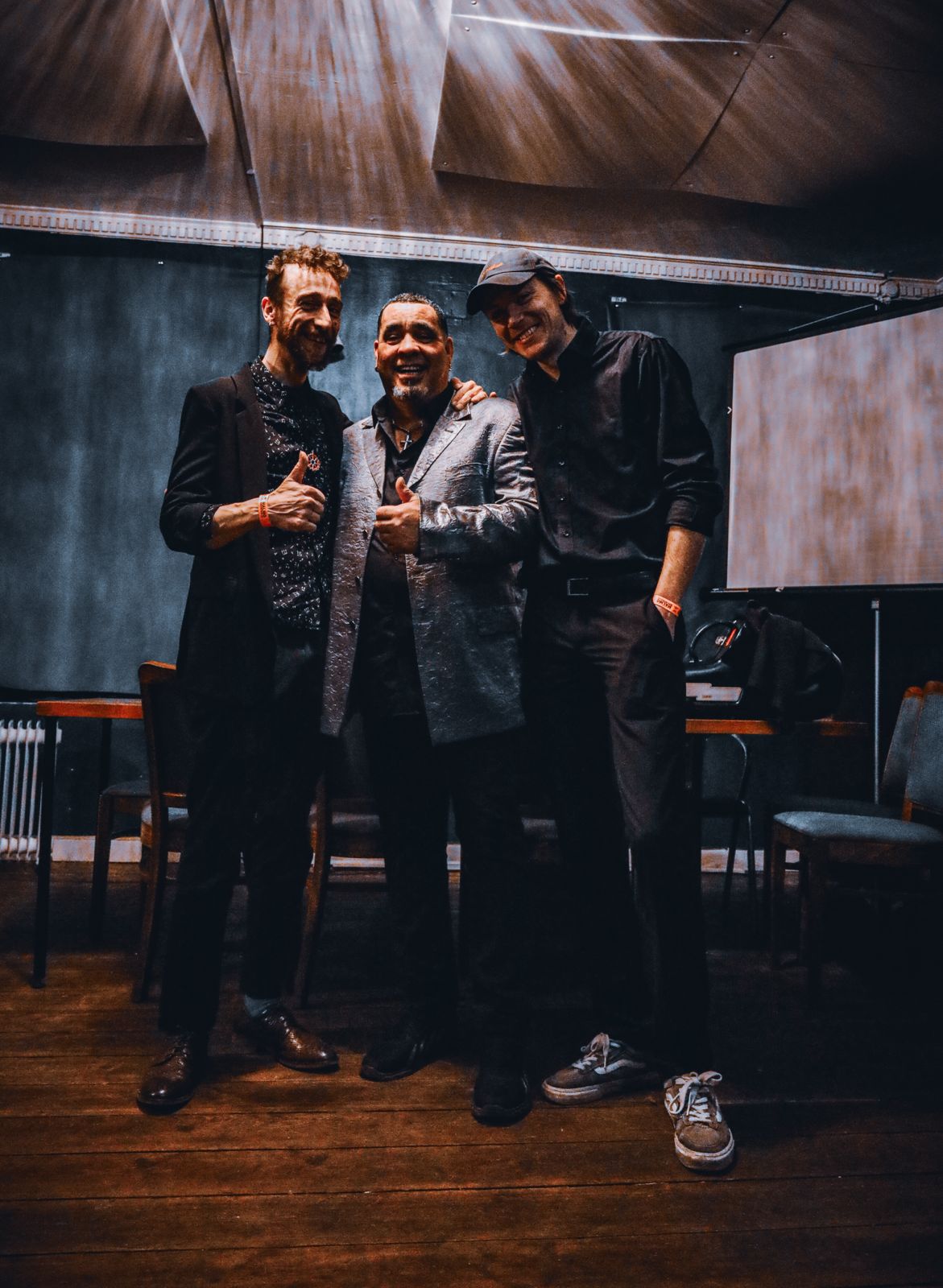Three band members giving thumbs up after the show