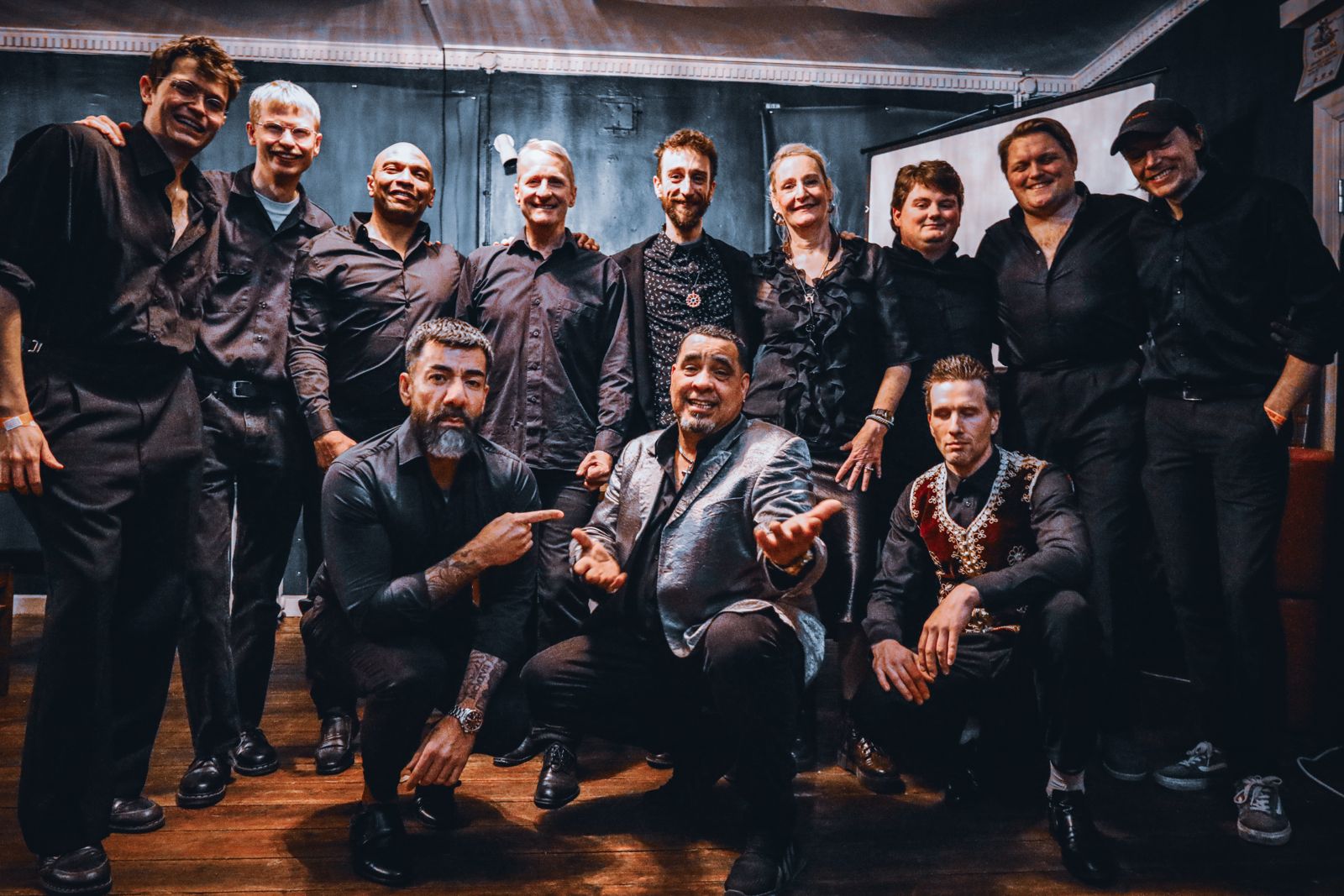 The twelve musicians of JL Son de Armonía backstage after a show